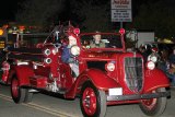 Lemoore's vintage fire truck in last year's Christmas Parade. The Volunteer Fire Dept. recently earned a high ISO rating making it one of the best departments in the country.